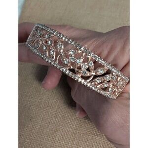 Rose gold colored rhinestone filigree floral pattern hinged bangle bracelet